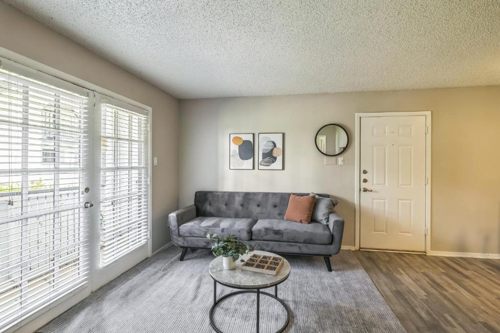 a living room with a couch and a table at C Springs 614 I Spacious 1 Bed 1 Bath in Bedford