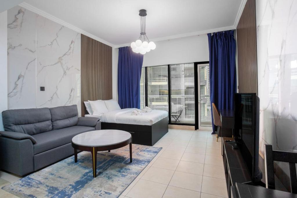 a living room with a couch and a table at Burj Al Nujoom Luxurious Apartment Downtown Dubai Mall in Dubai