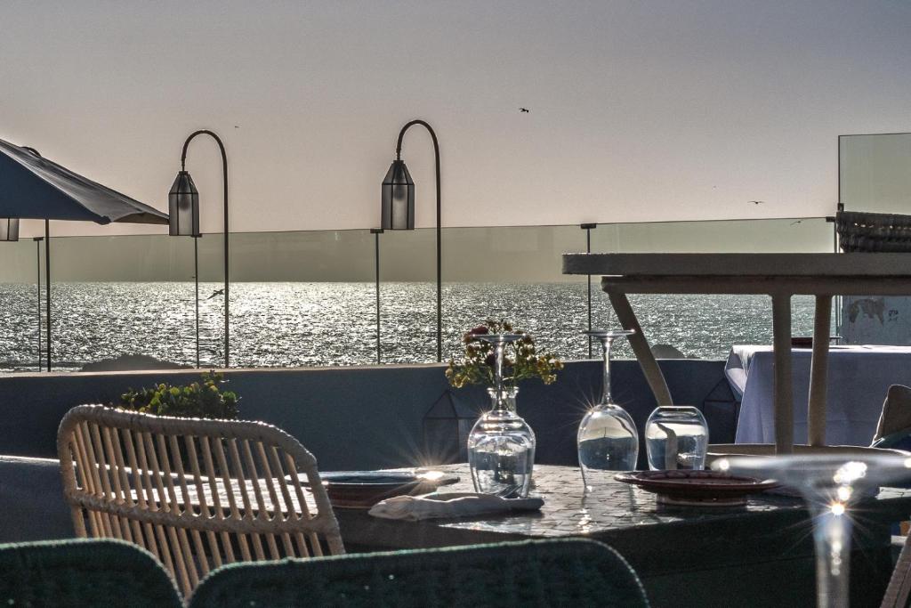 a table with chairs and wine glasses on a boat at Le Palazzo in Essaouira