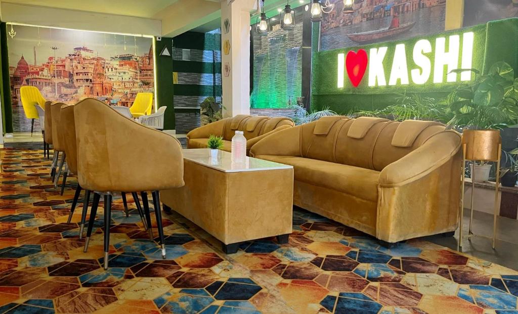 a lobby with couches and a table and chairs at Golden Lotus Varanasi in Varanasi