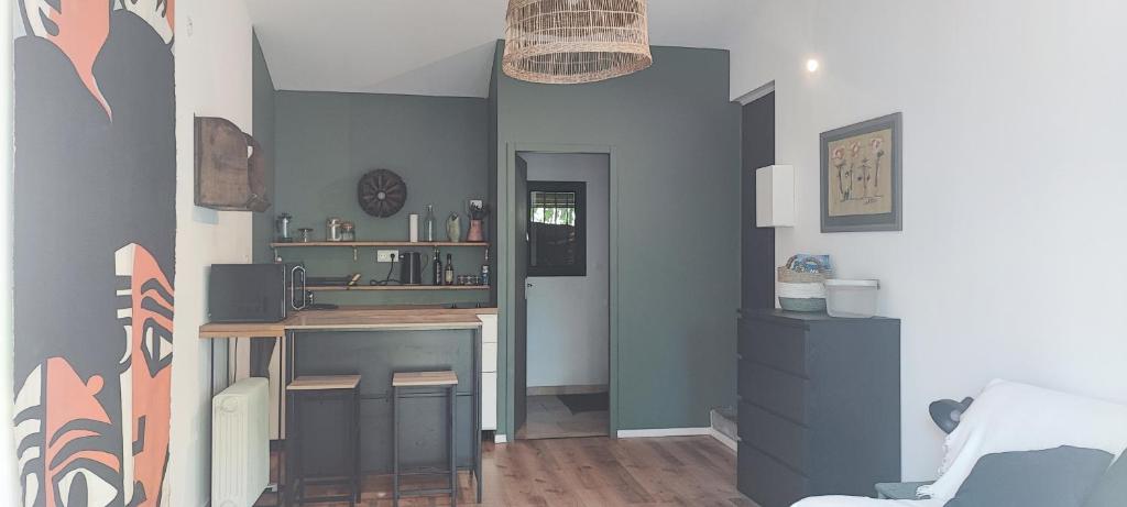 a room with a desk and a table in it at Studio au cœur de Buis-les-Baronnies in Buis-les-Baronnies