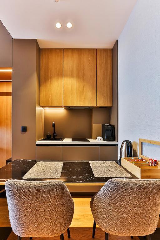 a kitchen with a table and two chairs at Regent Resort Budva in Budva