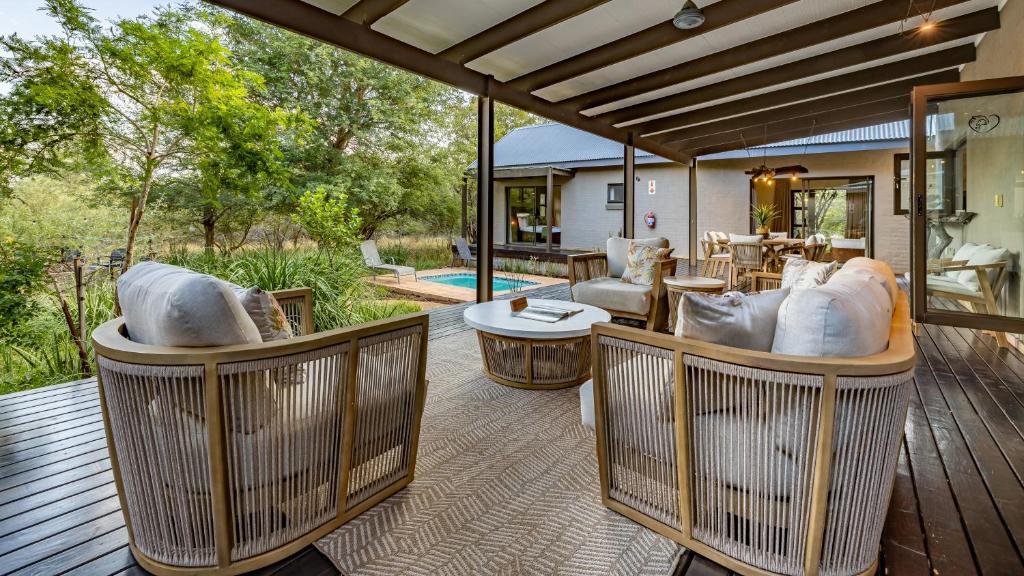 an outdoor living room with couches and tables at Wildheart Safari - MAIN in Hoedspruit