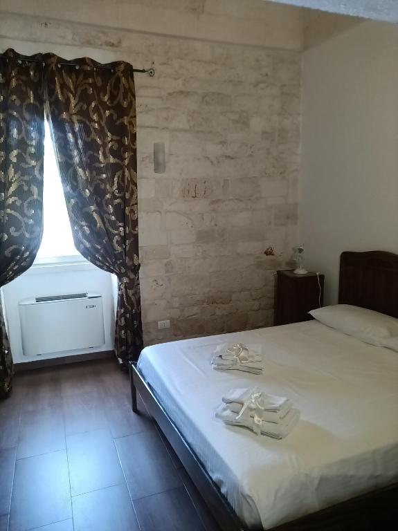 Posteľ alebo postele v izbe v ubytovaní Trulli in Martina Franca residence