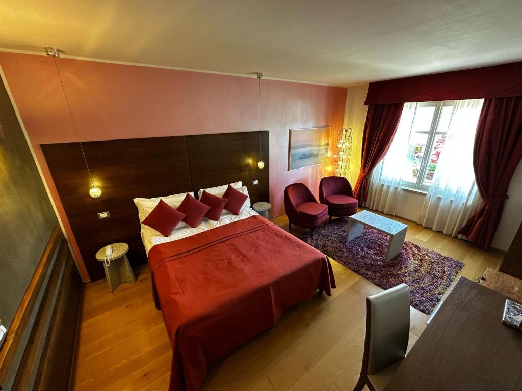 Postel nebo postele na pokoji v ubytování Hotel Cortese