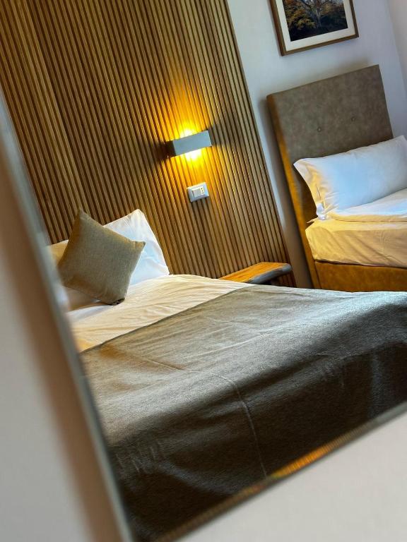 Postel nebo postele na pokoji v ubytování Hotel Cortese