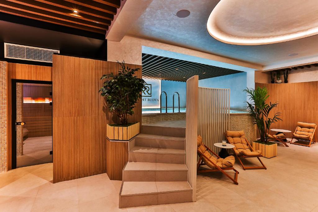 a lobby with a staircase in a building at Regent Resort Budva in Budva