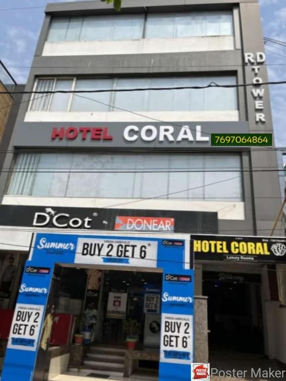 a hotel portal sign in front of a building at Hotel Coral in Indore