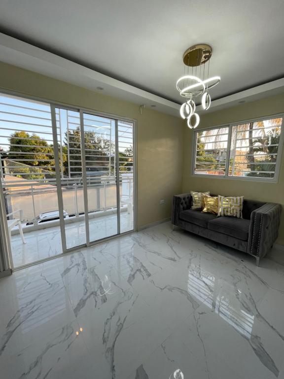 - un salon avec un sol en marbre et un canapé dans l'établissement Apartamento 2, à Cancino