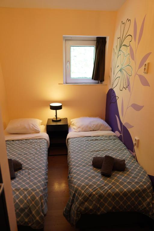 Postel nebo postele na pokoji v ubytování Onefam Amstel