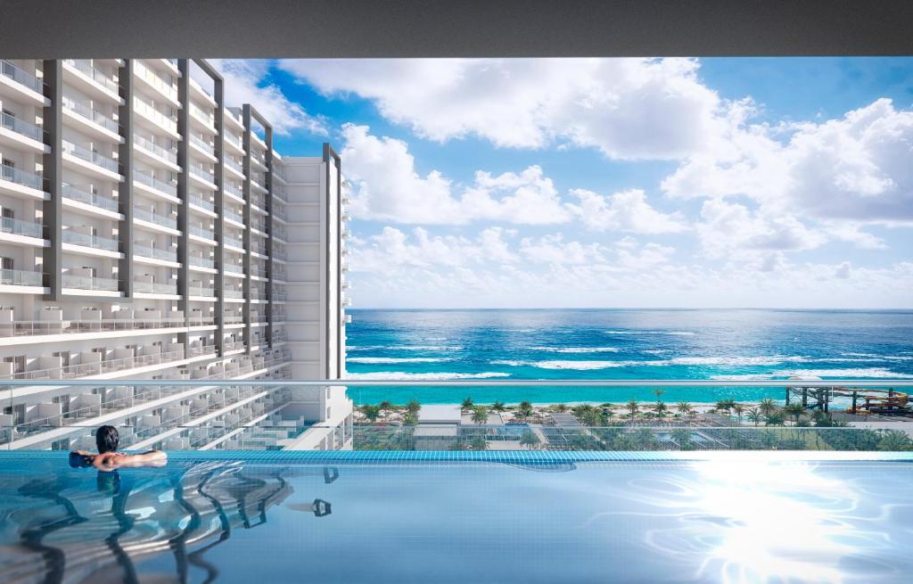eine Darstellung des Meerblicks von einem Hotelpool aus in der Unterkunft Riu Ventura - All Inclusive in Cancún