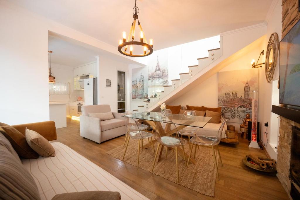 a dining room and living room with a glass table at Ingrit Gjoni Villas in Draç