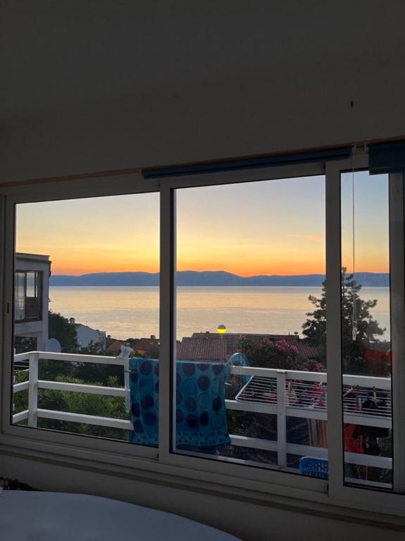 a view of the ocean from a bedroom window at Apartment Jenul in Labin