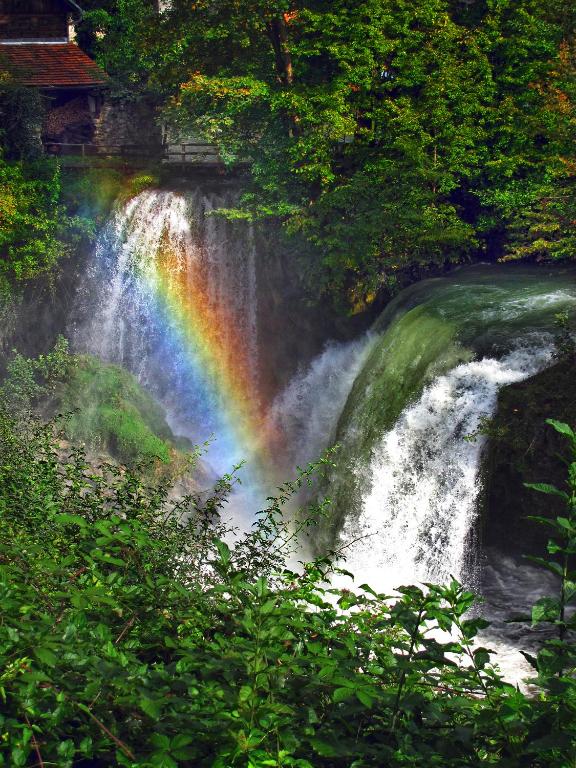a rainbow on the side of a waterfall at Rooms Roza in Slunj