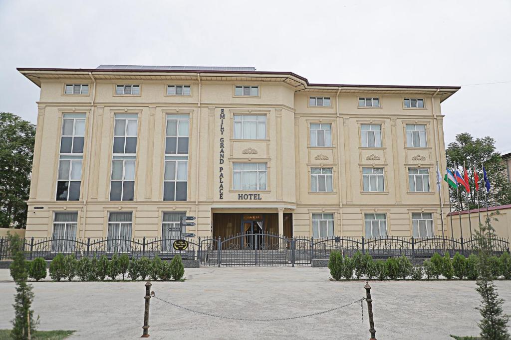 a large beige building with the front of it at Emily Grand Palace in Samarkand