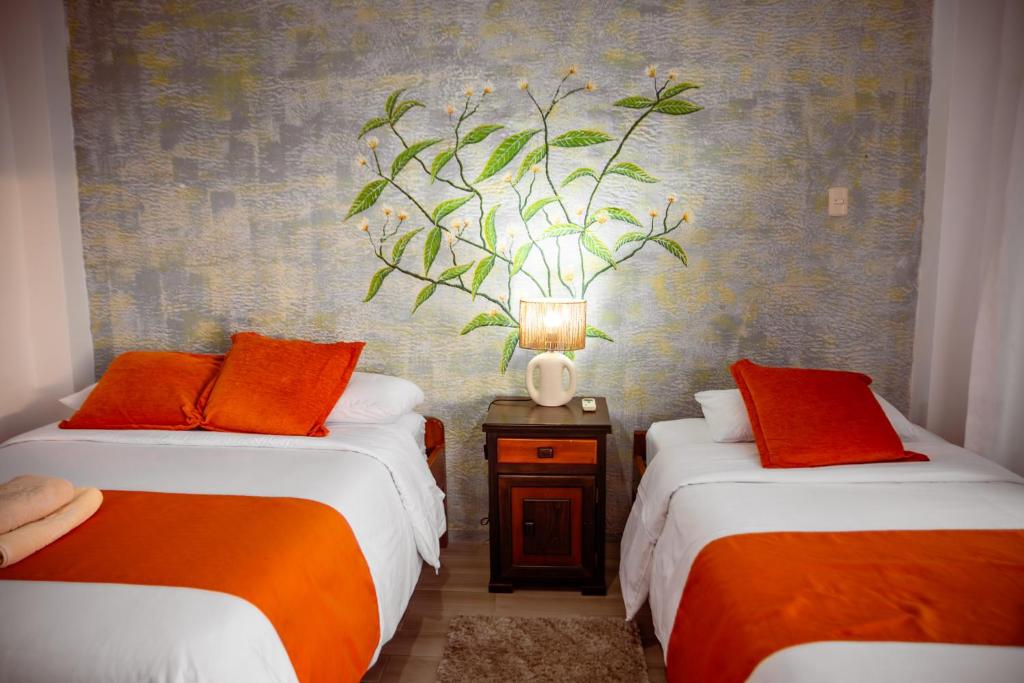 Postel nebo postele na pokoji v ubytování Hotel Miconia