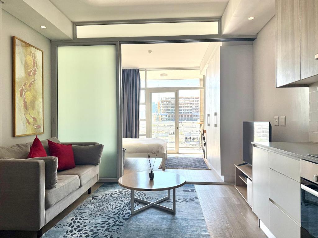 a living room with a couch and a table at City view studio apartment CBD in Cape Town