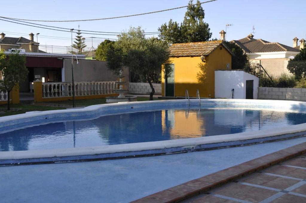 a swimming pool in a yard with a house at Casa Rural MATEOS in El Puerto de Santa María