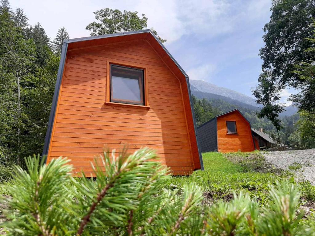 a small house with a window on the side of it at Camping & Glamping Grintovec in Preddvor