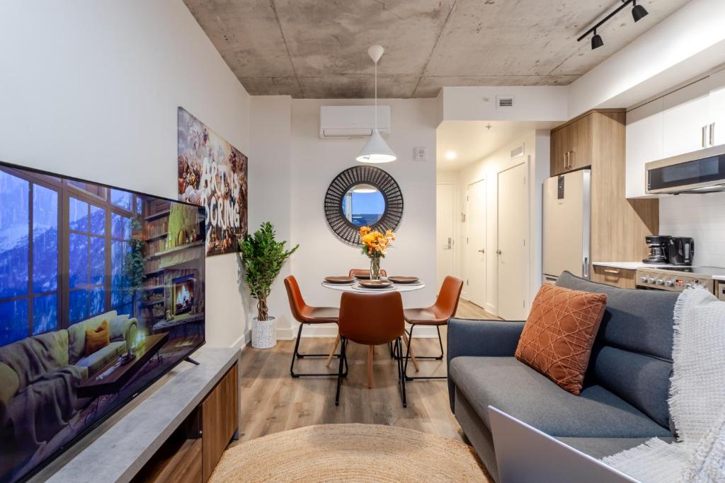 a living room with a couch and a table at Cute 1BDR Apt in Ste-Catherine - MTL Live Spot in Montréal
