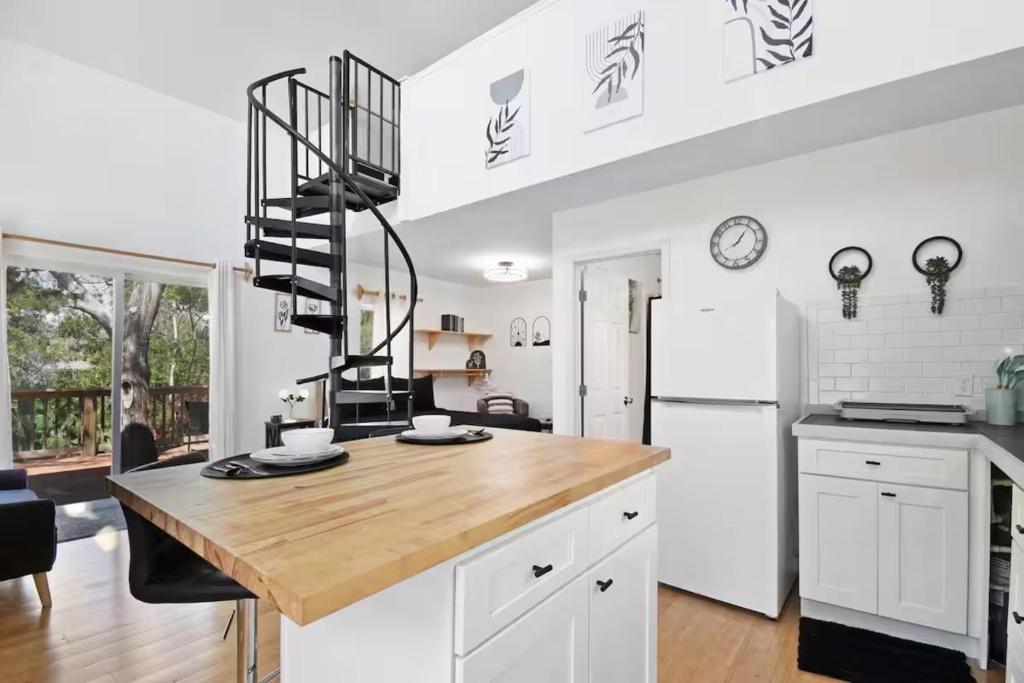 a kitchen with a wooden counter top and a white refrigerator at Anastasia Island Treehouse in St. Augustine