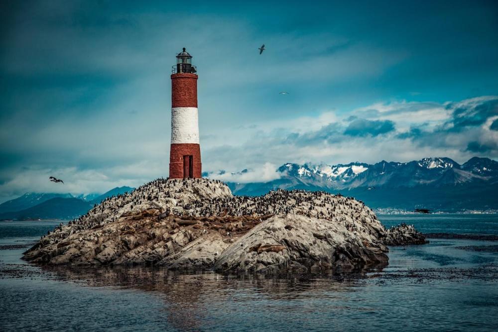a lighthouse on an island in the water at Monte susana 2 in Ushuaia