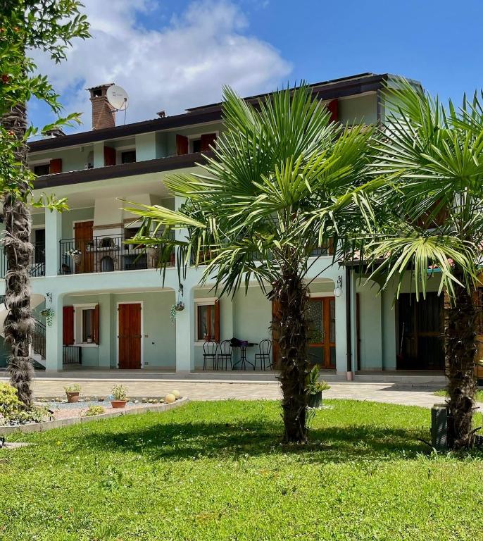 a house with palm trees in front of it at Casa colibrì in San Giovanni