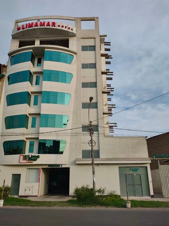 a building with a sign on top of it at Hotel Limamar in Lima