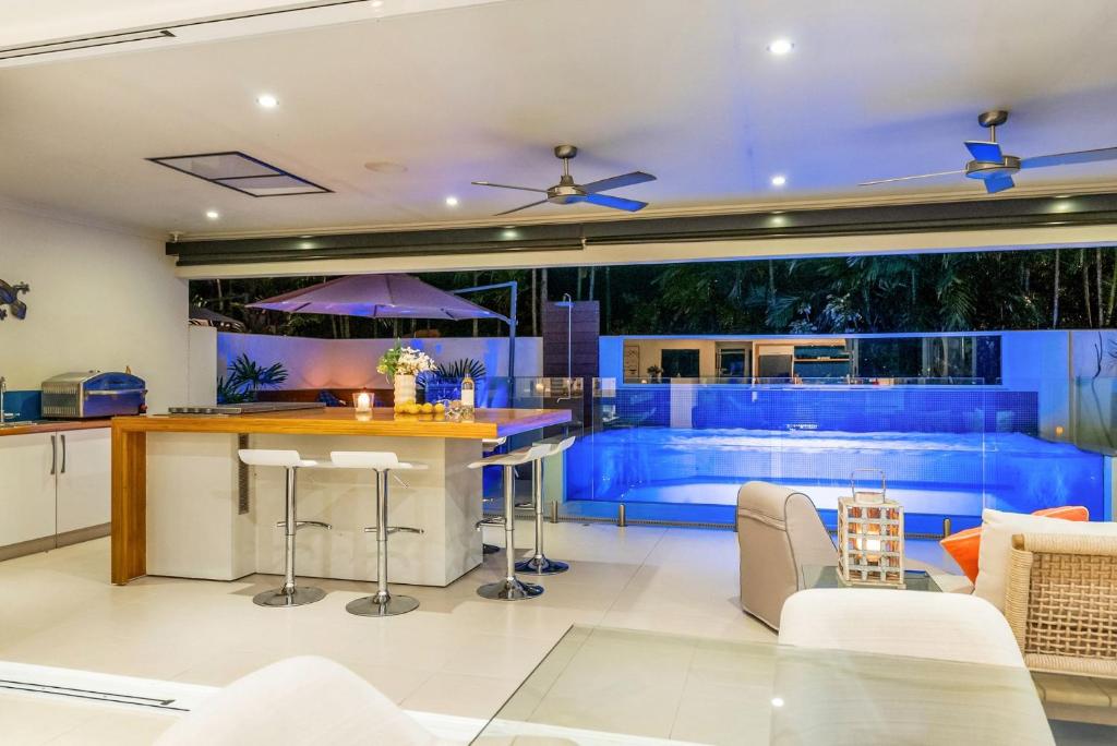a kitchen and living room with a swimming pool at Belle Escapes Chillandos in Smithfield