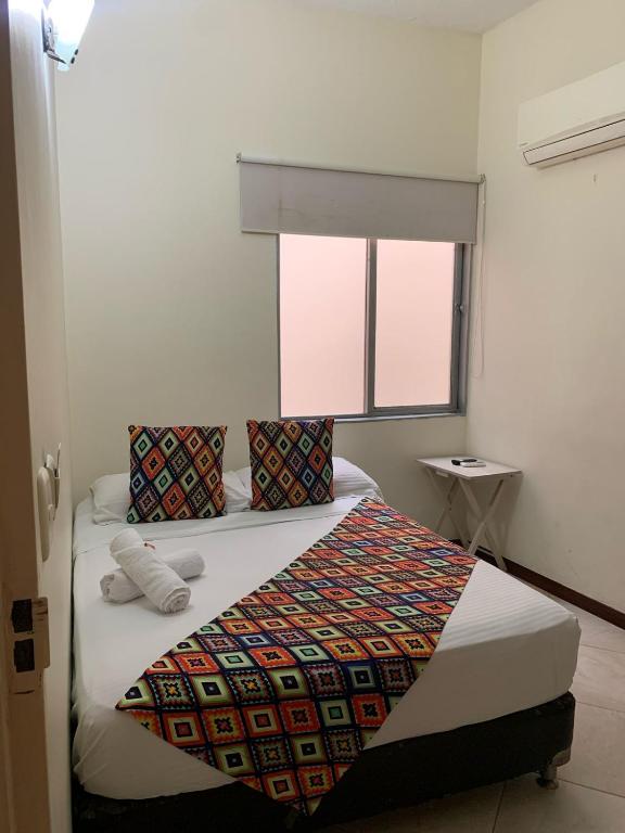 Postel nebo postele na pokoji v ubytování Hotel Tierra Santa Santa Fe de Antioquia