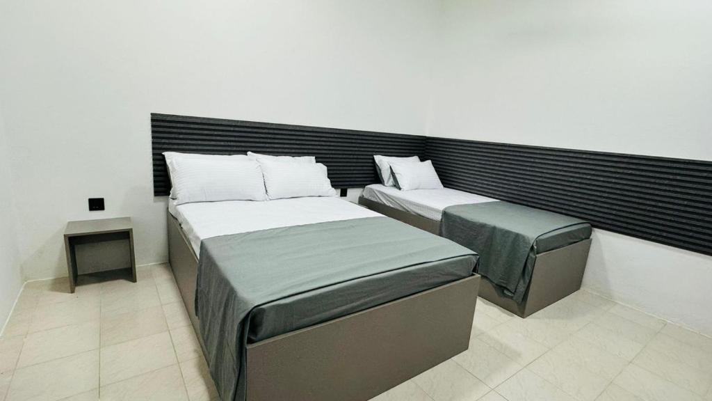 Postel nebo postele na pokoji v ubytování Reinforce Residence