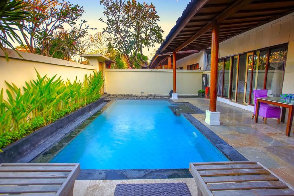 a swimming pool in the backyard of a house at Private Pool Villas Kuta Bali in Badung