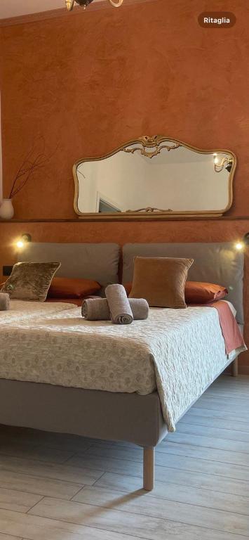 a bedroom with a bed with a mirror on the wall at Casa Rossana - 15min from Venice in Mestre