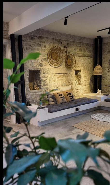 a bedroom with a bed in a brick wall at NisUrla in Urla