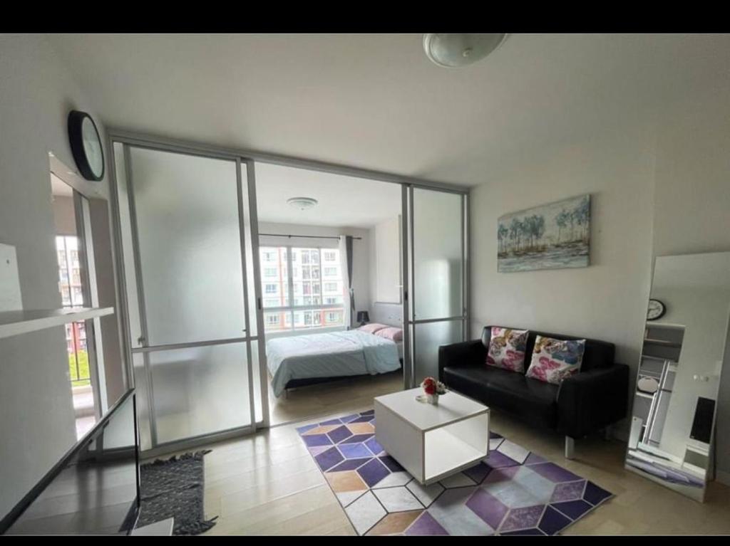 a living room with a couch and a bed at D Condo phuket kathu- patong in Amphoe Kathu