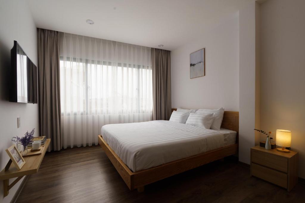 Postel nebo postele na pokoji v ubytování LATA Hotel & Apartments