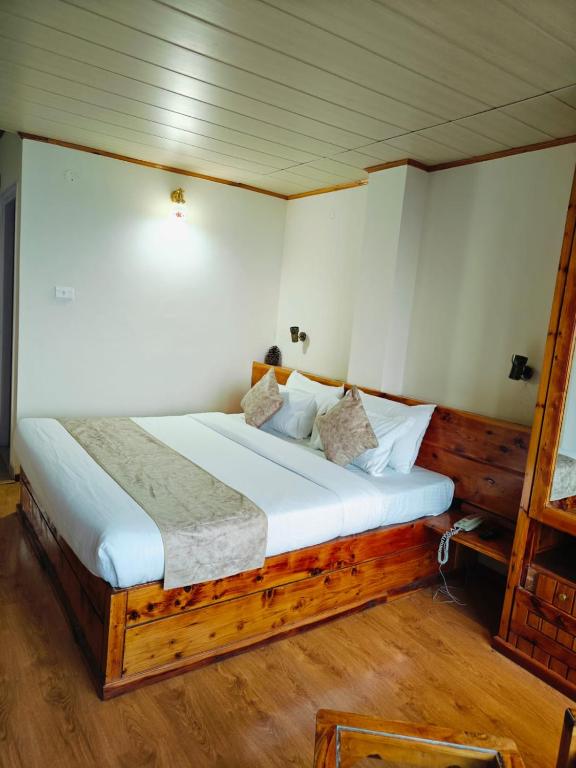 Postel nebo postele na pokoji v ubytování Hotel Sudrishya
