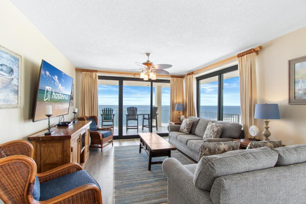 a living room with a couch and a table at Windward Pointe Condominiums in Orange Beach