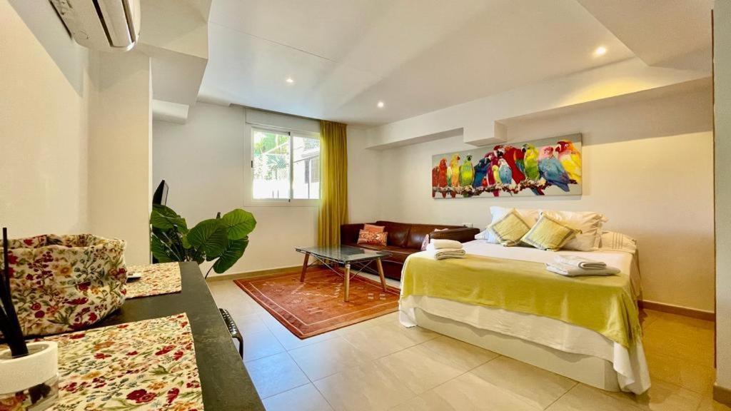 a bedroom with a large bed and a couch at Beach Panorama in Marbella