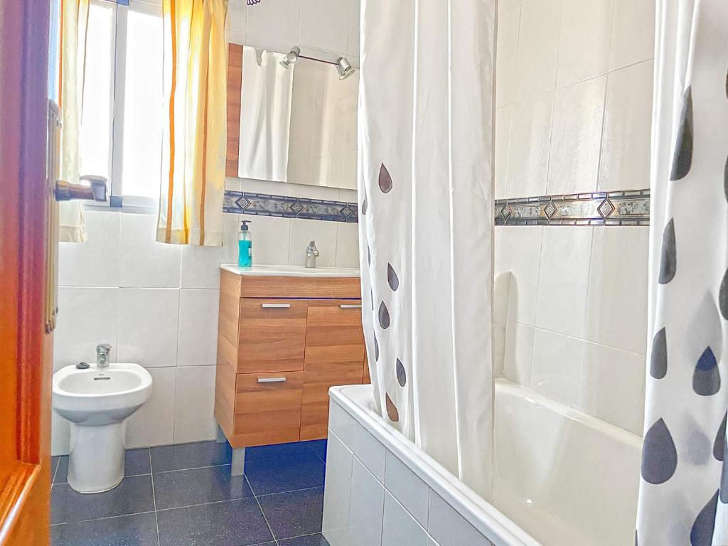 a bathroom with a sink and a toilet and a shower at Villa Francisca in Málaga
