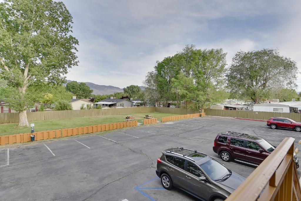 a parking lot with two cars parked in it at Vagabond Inn Bishop in Bishop
