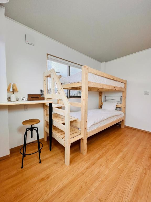 a bedroom with two bunk beds and a desk at hotel kusanagi in Nanao