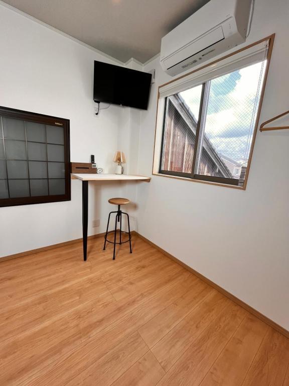 a small room with a desk and a window at hotel kusanagi in Nanao