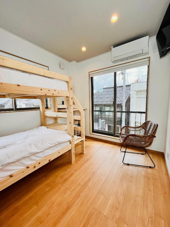 a bedroom with two bunk beds and a chair at hotel kusanagi in Nanao