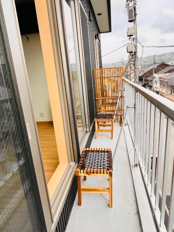 a balcony with a bench and a chair on it at hotel kusanagi in Nanao