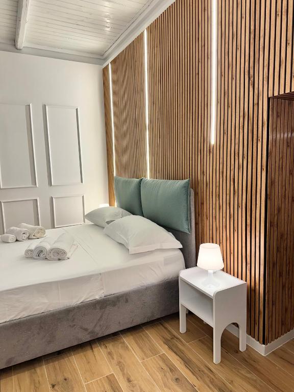 a bedroom with a bed and a side table at Portobello In Centro in Salerno
