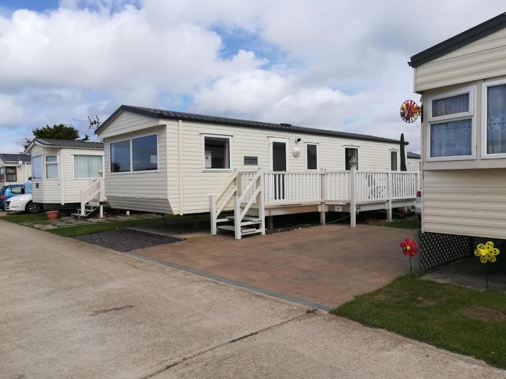 a white mobile home parked in a parking lot at Moonstone Hayling Island Holiday Park in South Hayling
