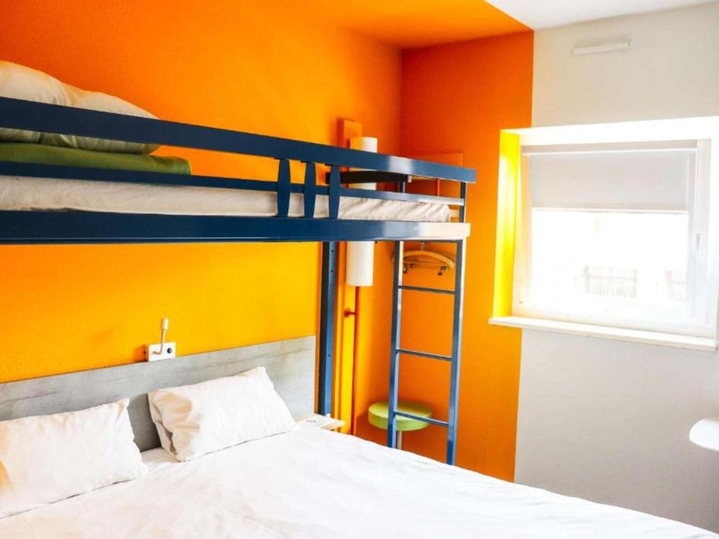 Postel nebo postele na pokoji v ubytování ibis Budget Colmar Centre Gare