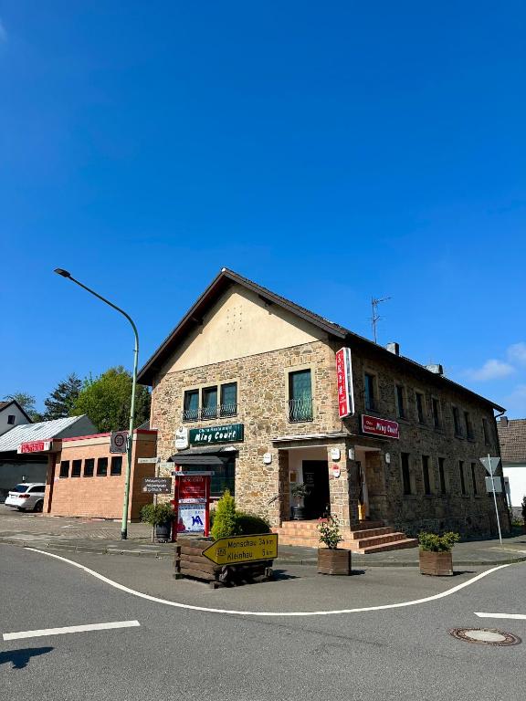 an old brick building on the corner of a street at Hotel Restaurant Ming Court in Hürtgenwald