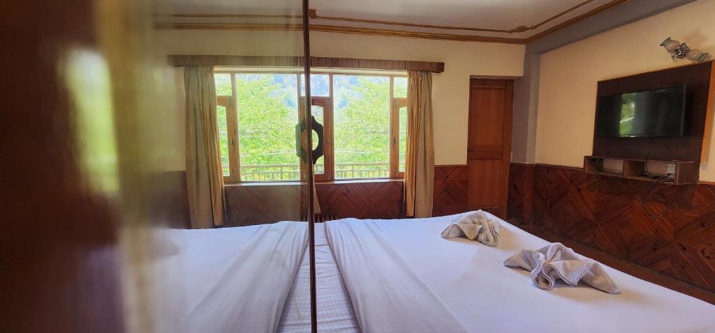 Postel nebo postele na pokoji v ubytování Hostelam The Mountain Story